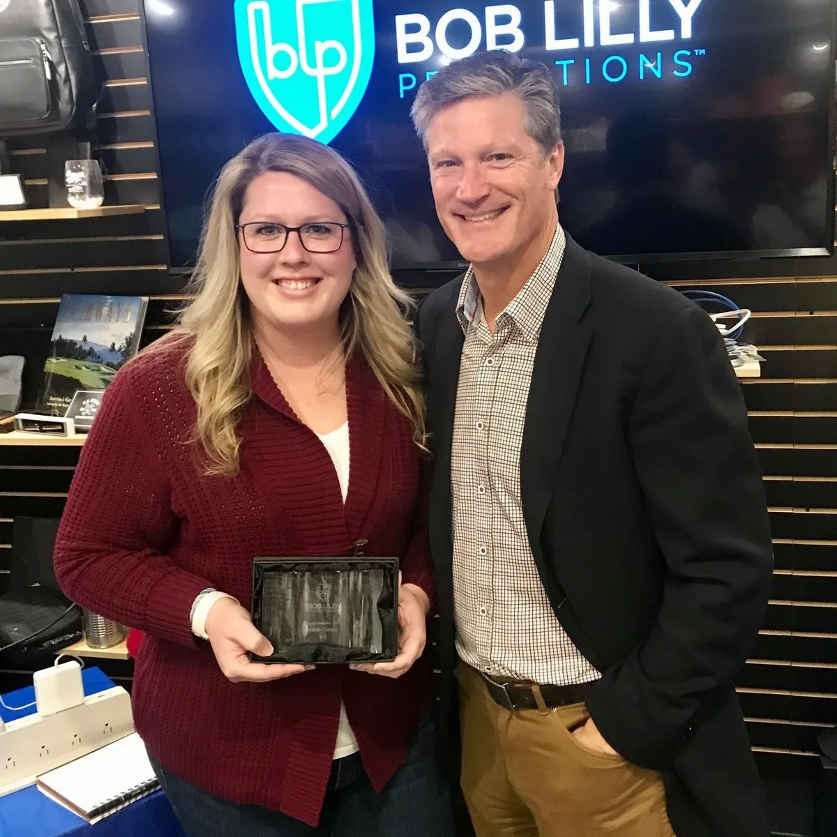 BLP employee receiving a custom crystal recognition award at the annual Bob Lilly Promotions awards celebration