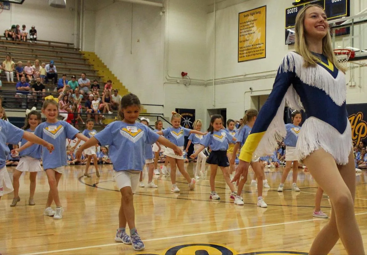 Young dancers at Highland Belles camp wearing light blue camp t-shirts in the Highland Park gym